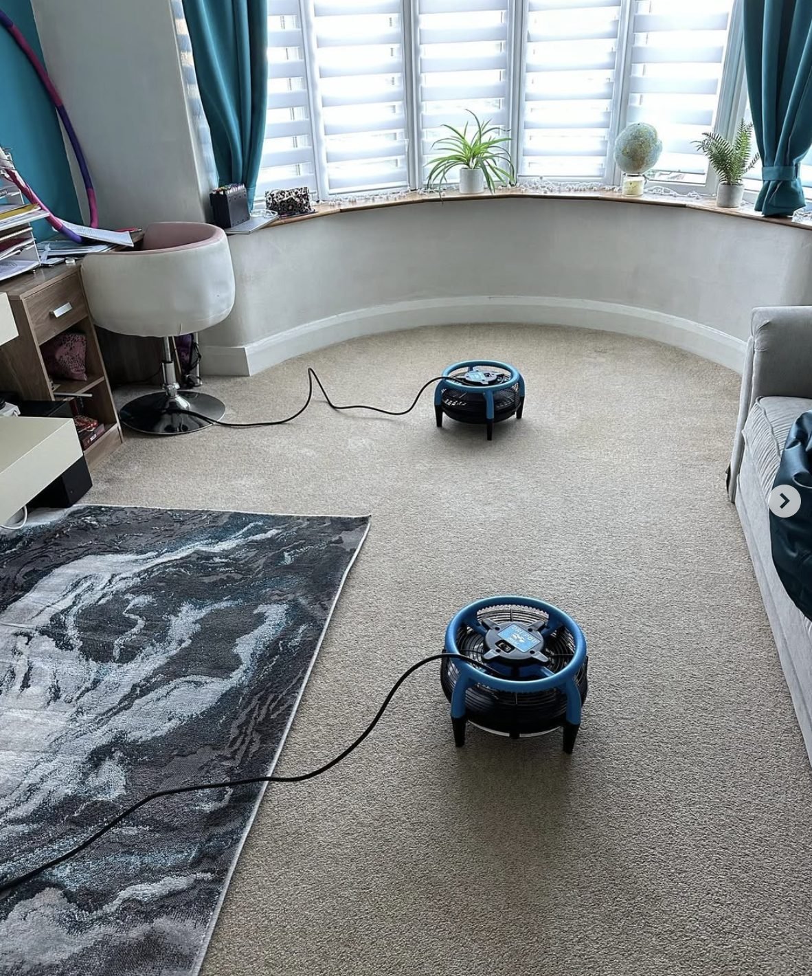 Air movers drying a bay-window lounge