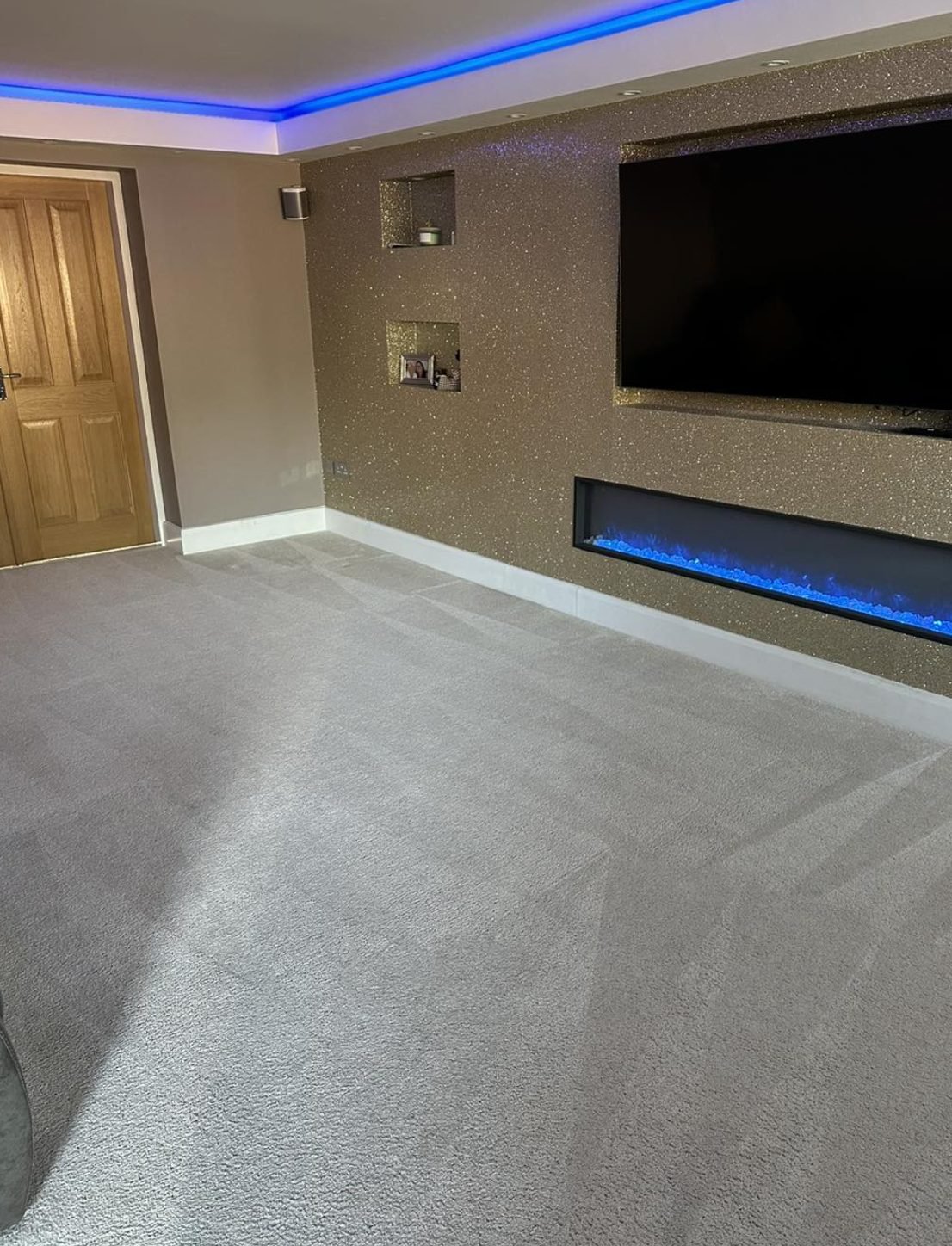 Living room carpet against a feature wall